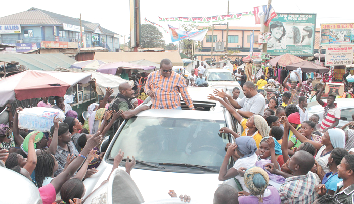 Dr Hassan Ayariga mobbed by traders during his visit to the Madina market. Picture: MAXWELL OCLOO